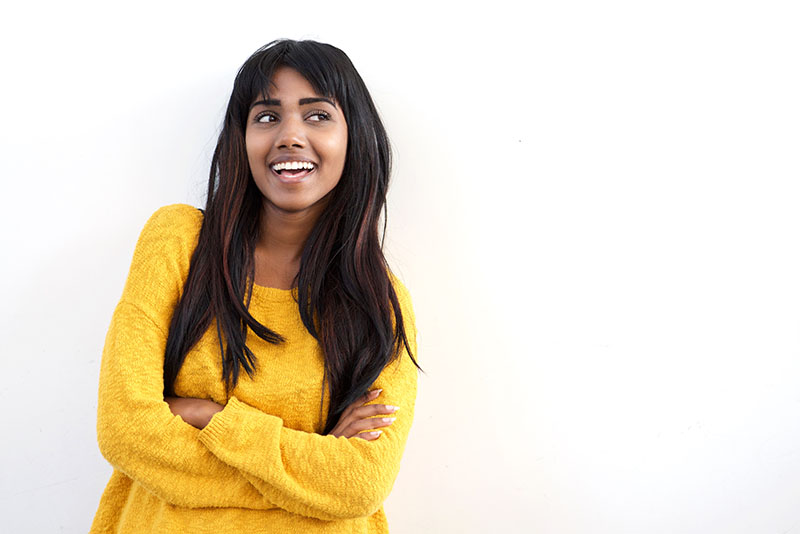 Attractive Young Indian Woman Smiling And Glancing At Copy Space